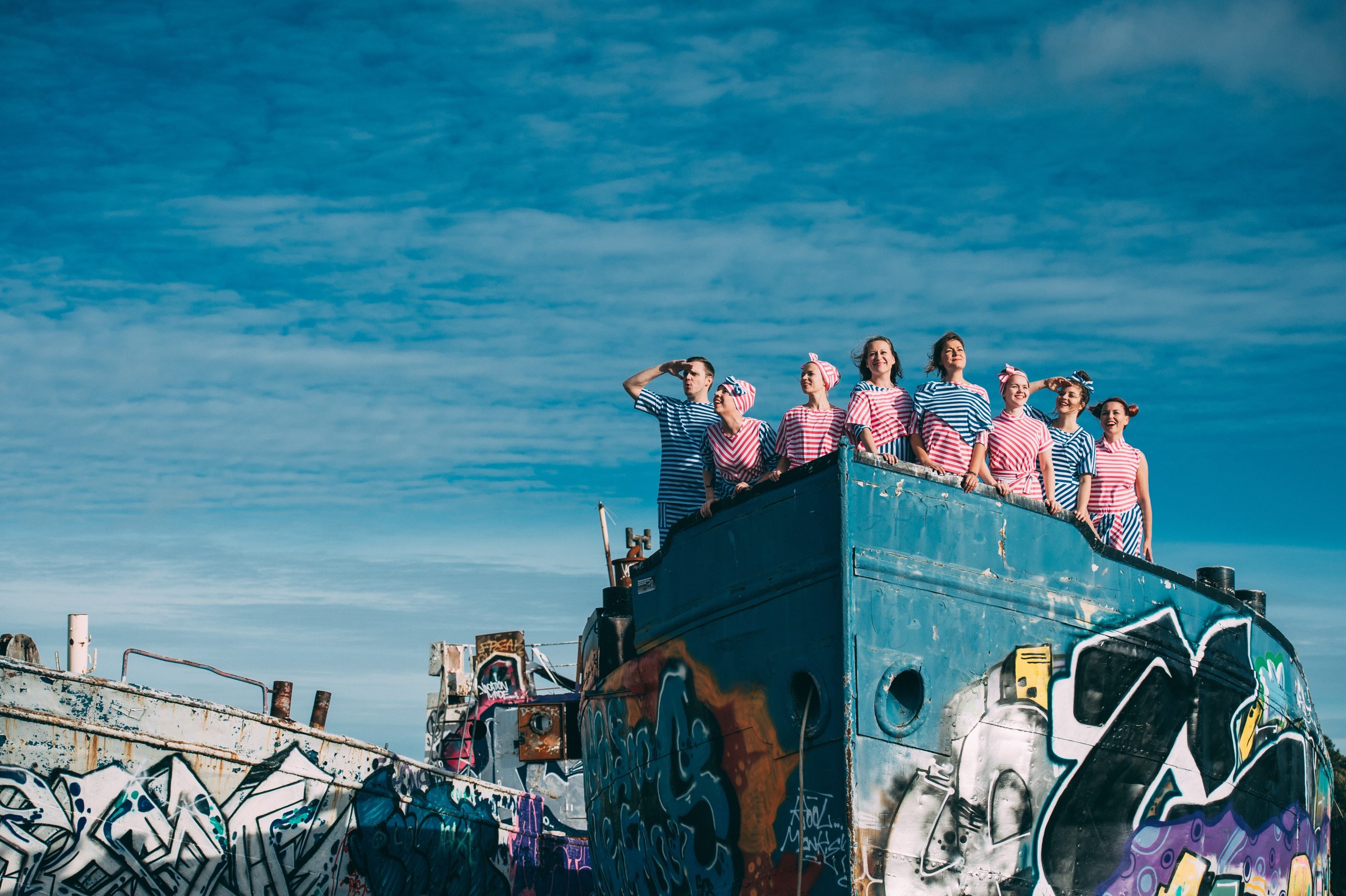 People in striped clothes on a ship.